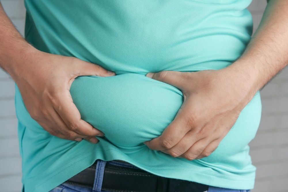 Hombre sujetando su barriga